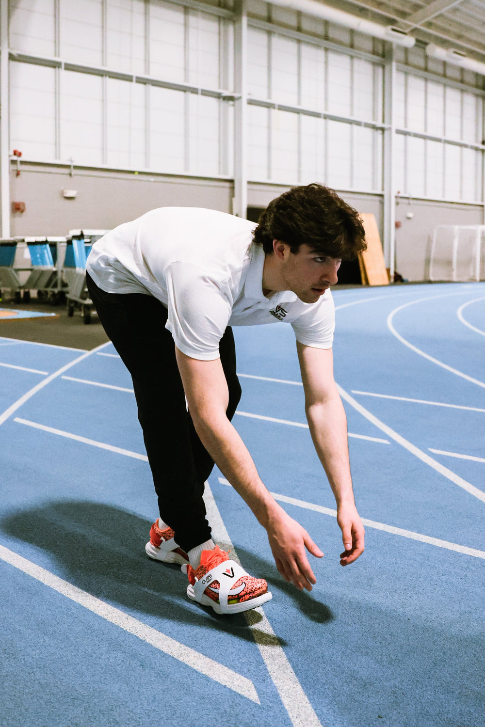 Person preparing to run on an indoor track with CUVS